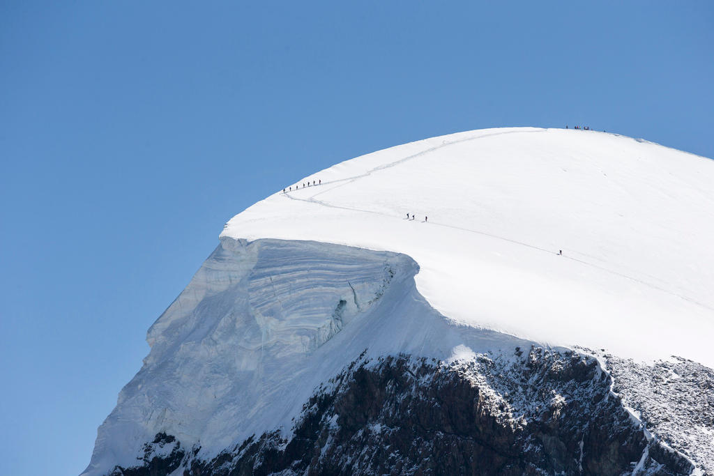 Mountaineers hike on the peak of the Breithorn mountain