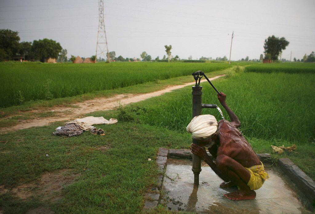 Man drinking at a well