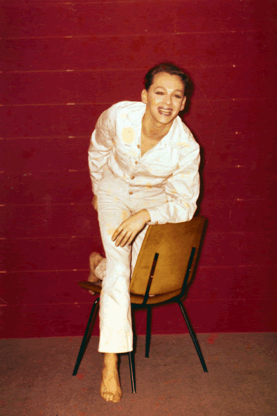 A man leans on a chair
