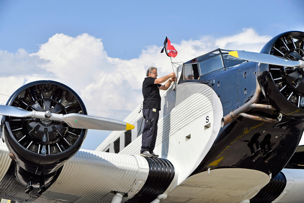A worker prepares a JU-52 vintage plane in Dübendorf, Zurich, on August 17, 2018, ahead of the resumption of operations