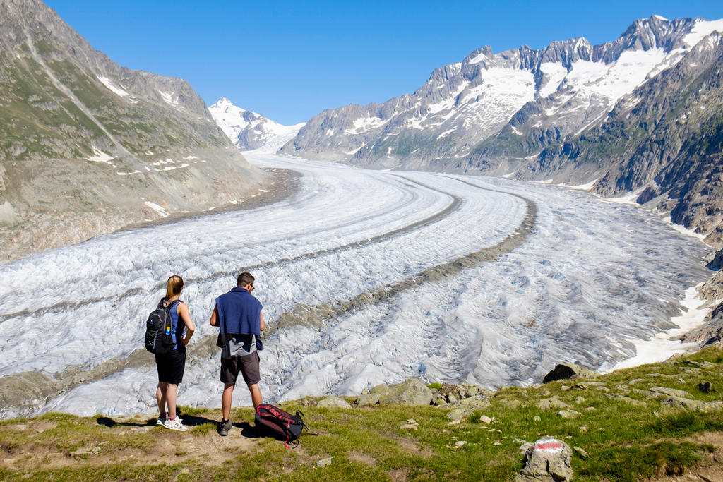 Two people stand near to the Aletsch glacier