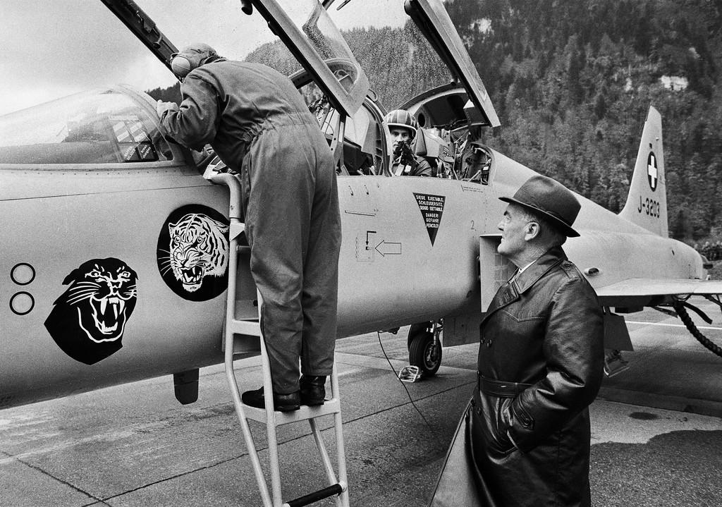 black and white photo of a fighter jet and two men