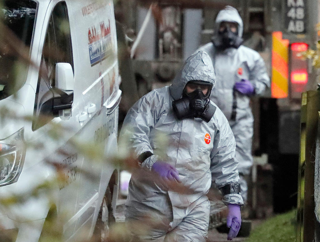 Personnel in protective gear and masks