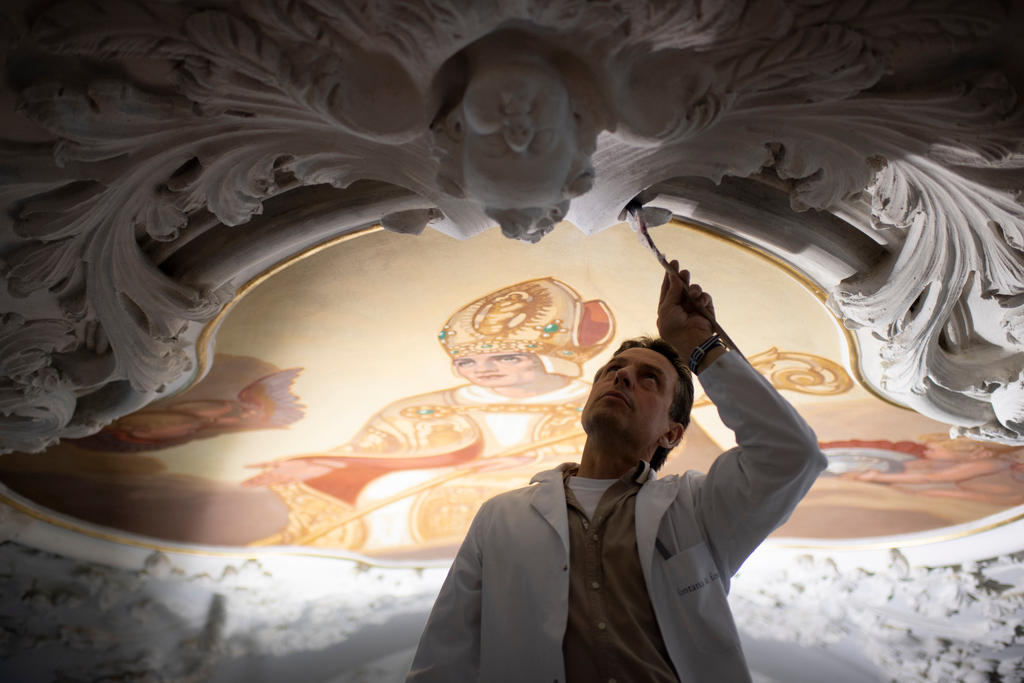 A restorer working on a fresco at the 1400-year-old Disentis Monastery