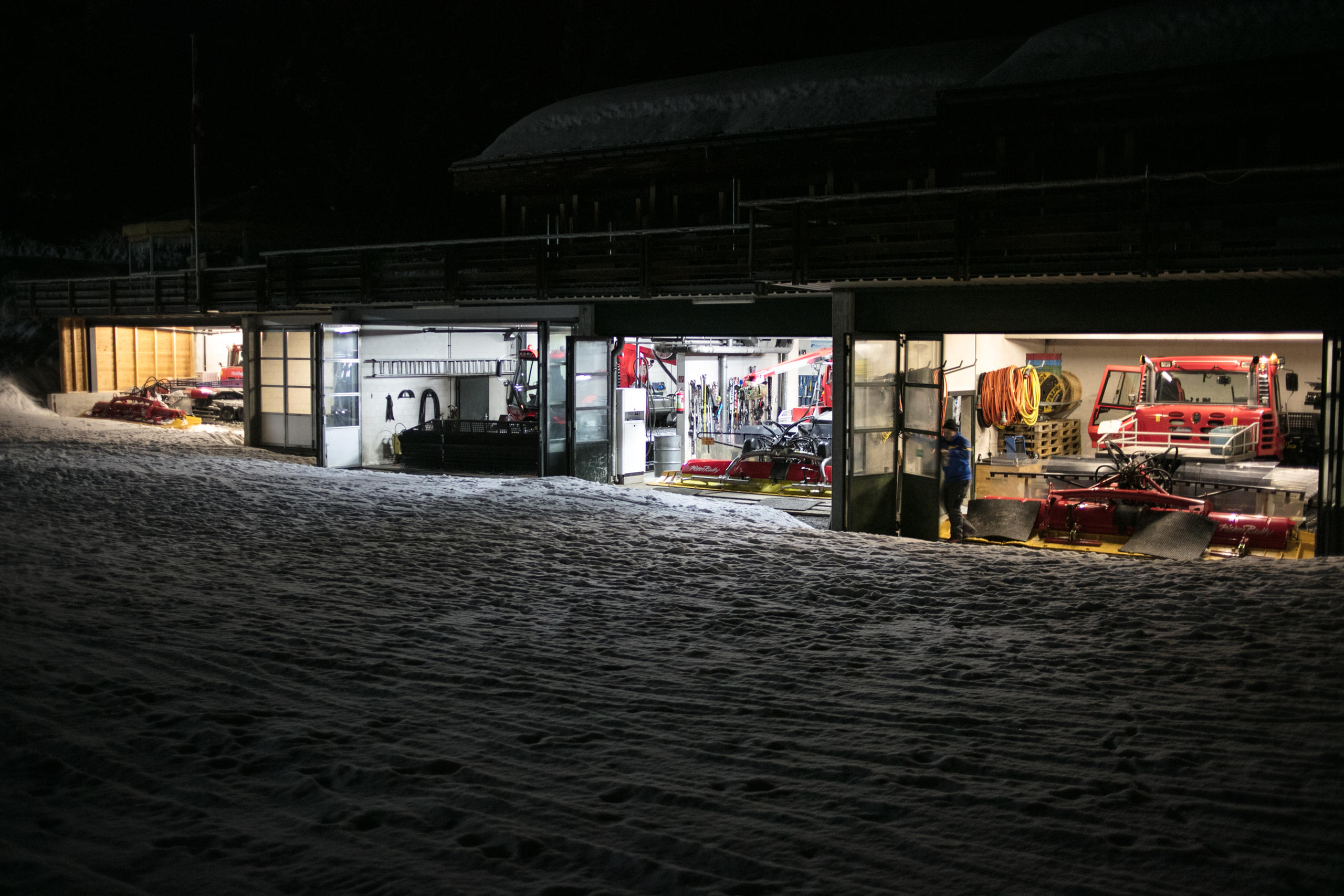 Four piste bashers in a lit garage