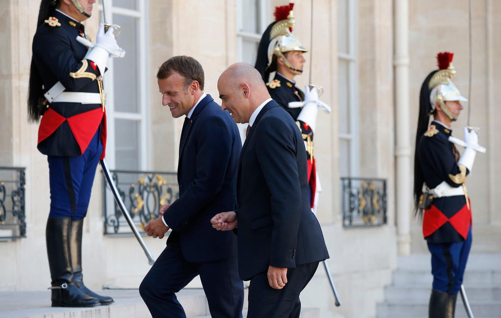 two men in suits plus three soldiers