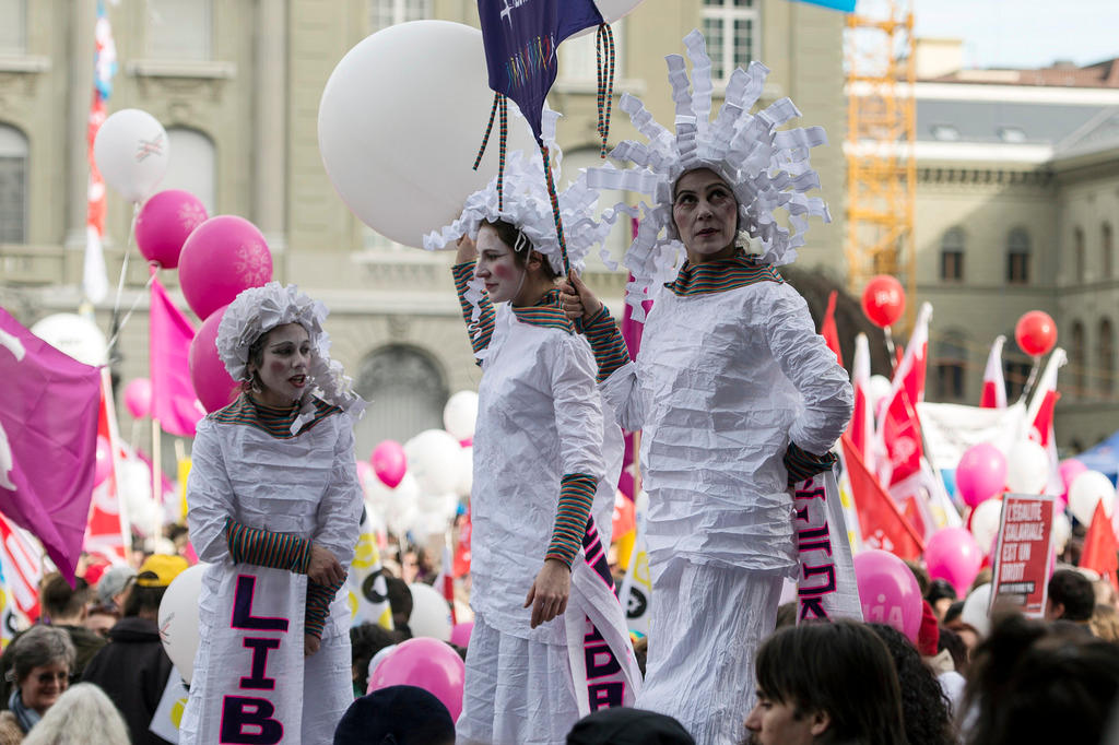Frauen in weissen Kostümen demonstrieren gegen Lohnungleichheit