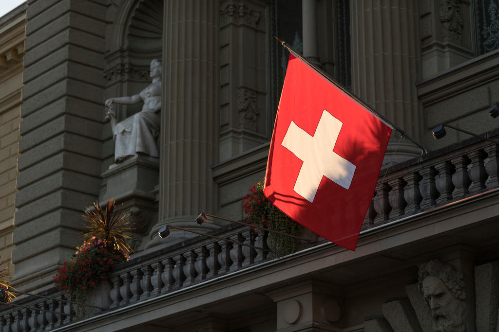 A Swiss flag flies outside the Federal Palace in Bern