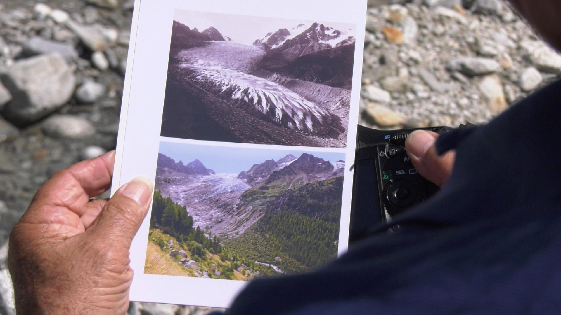 Hands holding pictures of glaciers