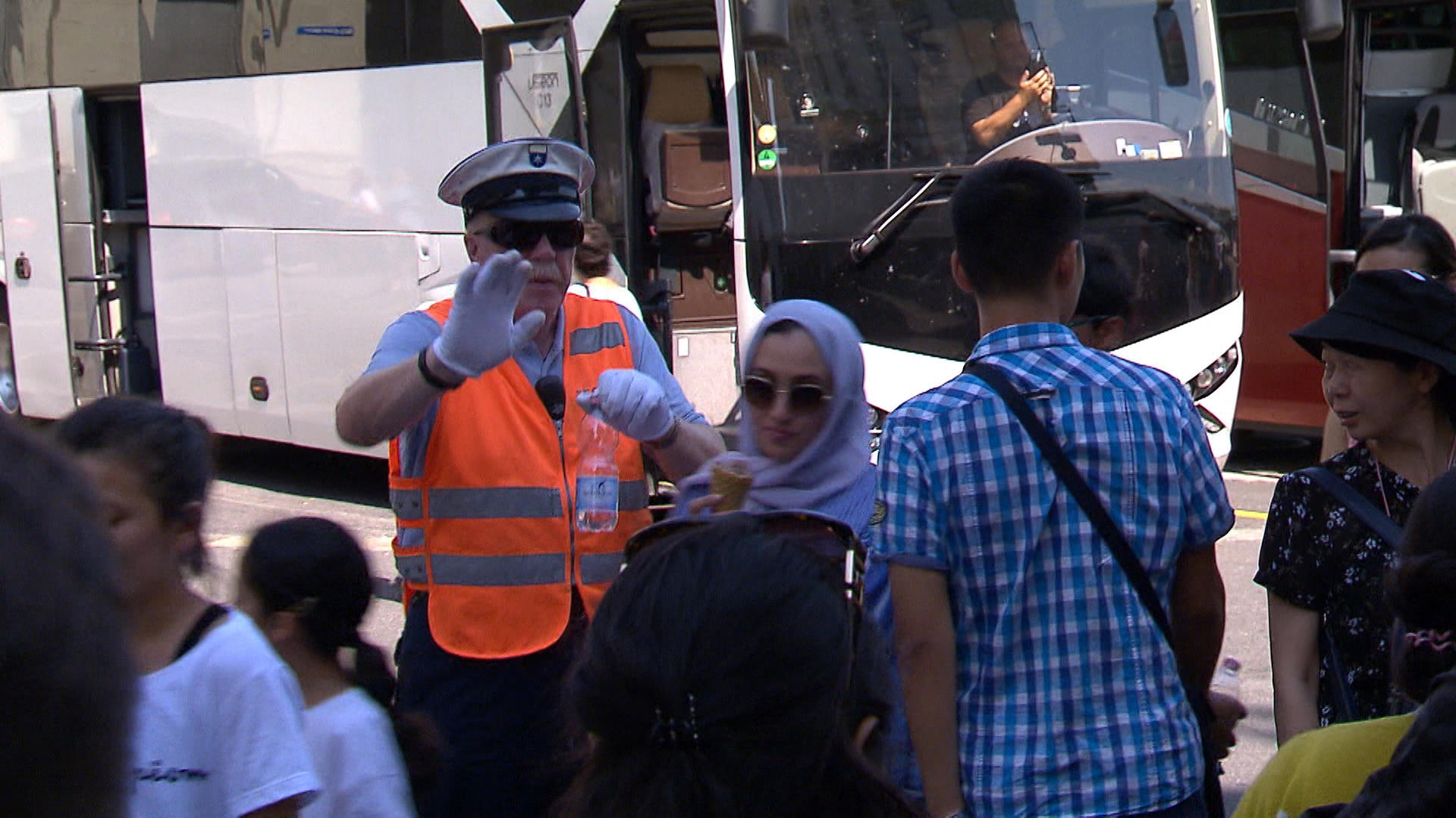 Security guard holds tourists back