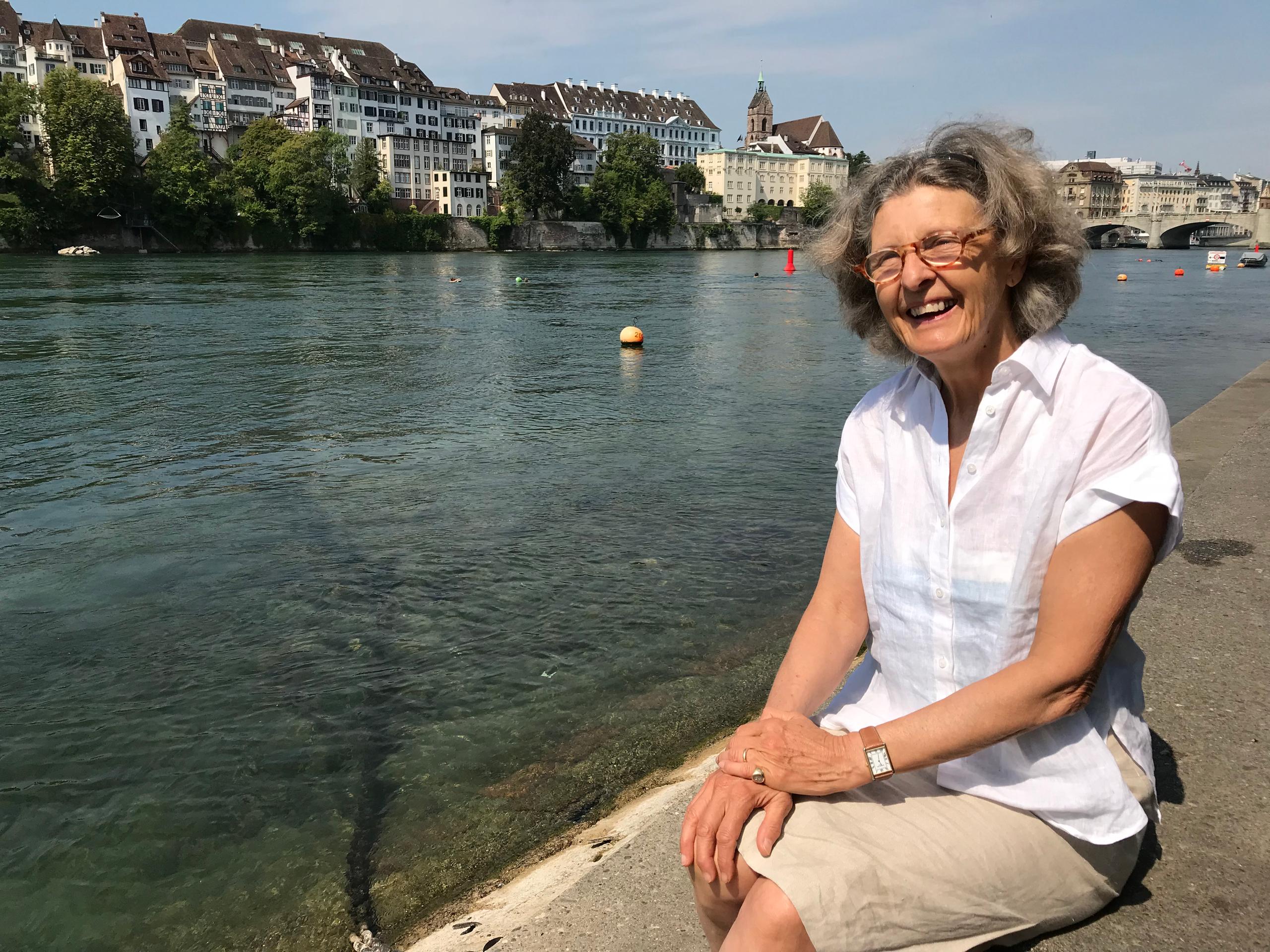woman sitting on riverbank