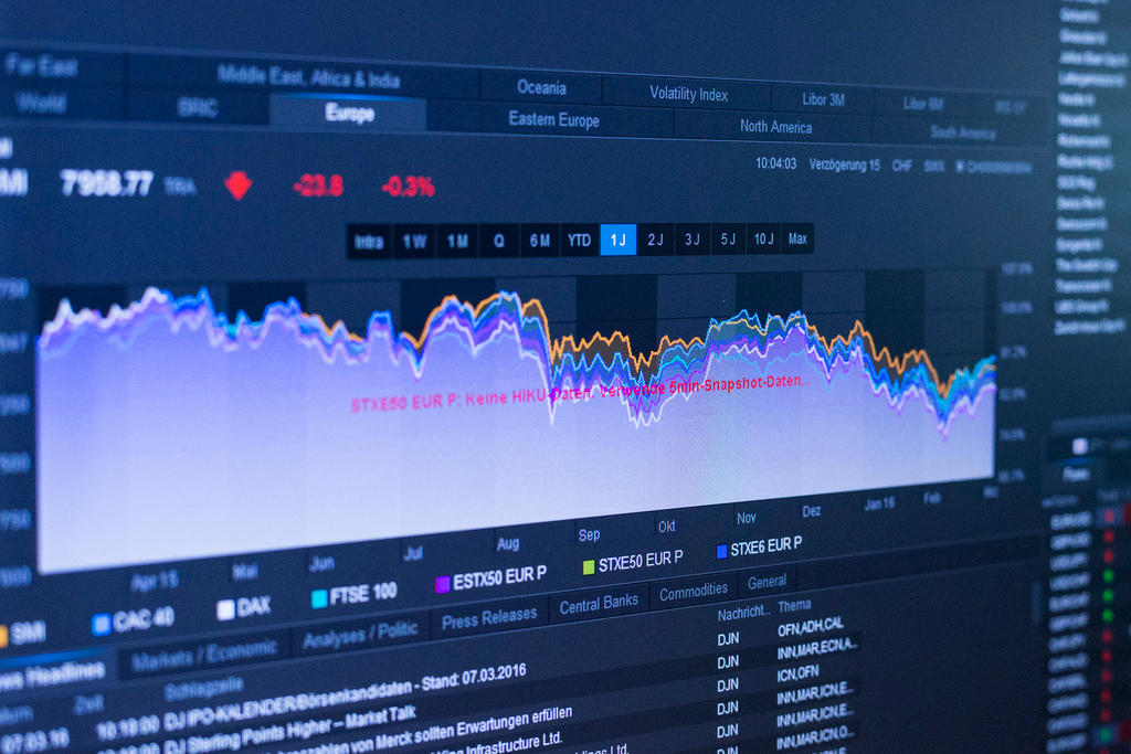 Stock exchange screen shows trading charts