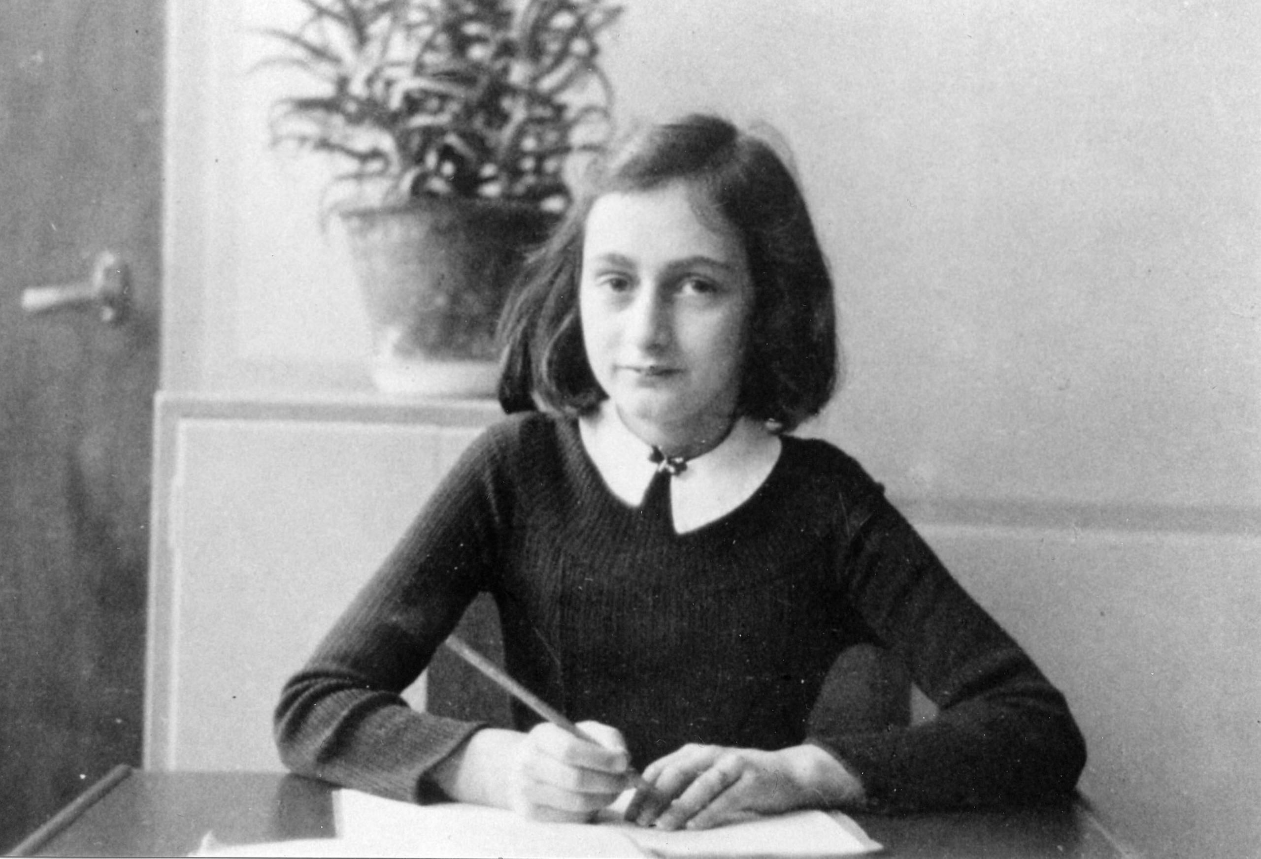 Anne Frank at her desk in Amsterdam