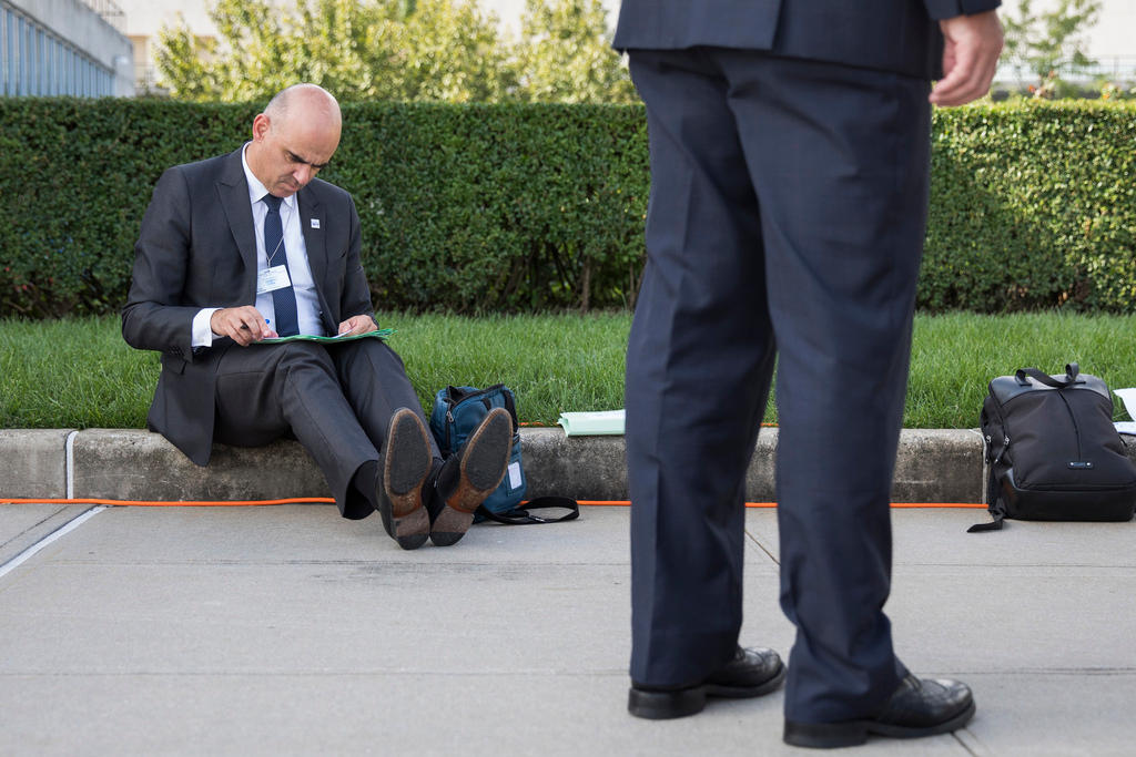 man in suit sitting on ground