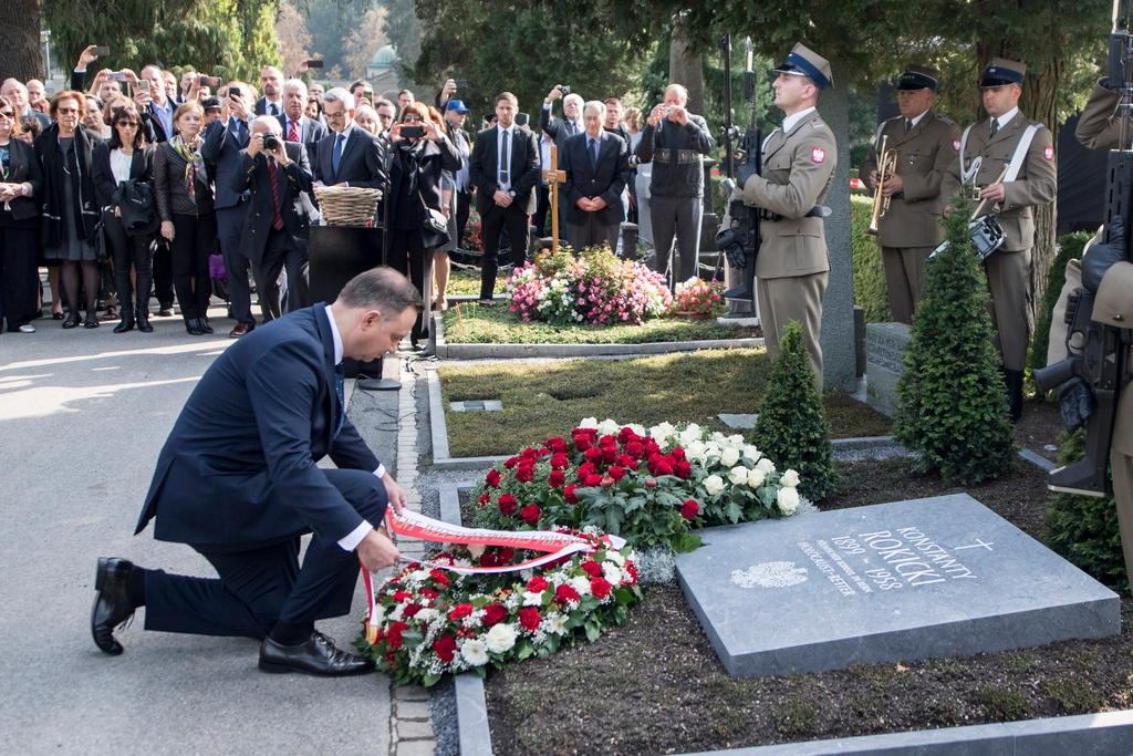 Polish President Andrzej Duda lays a wreath