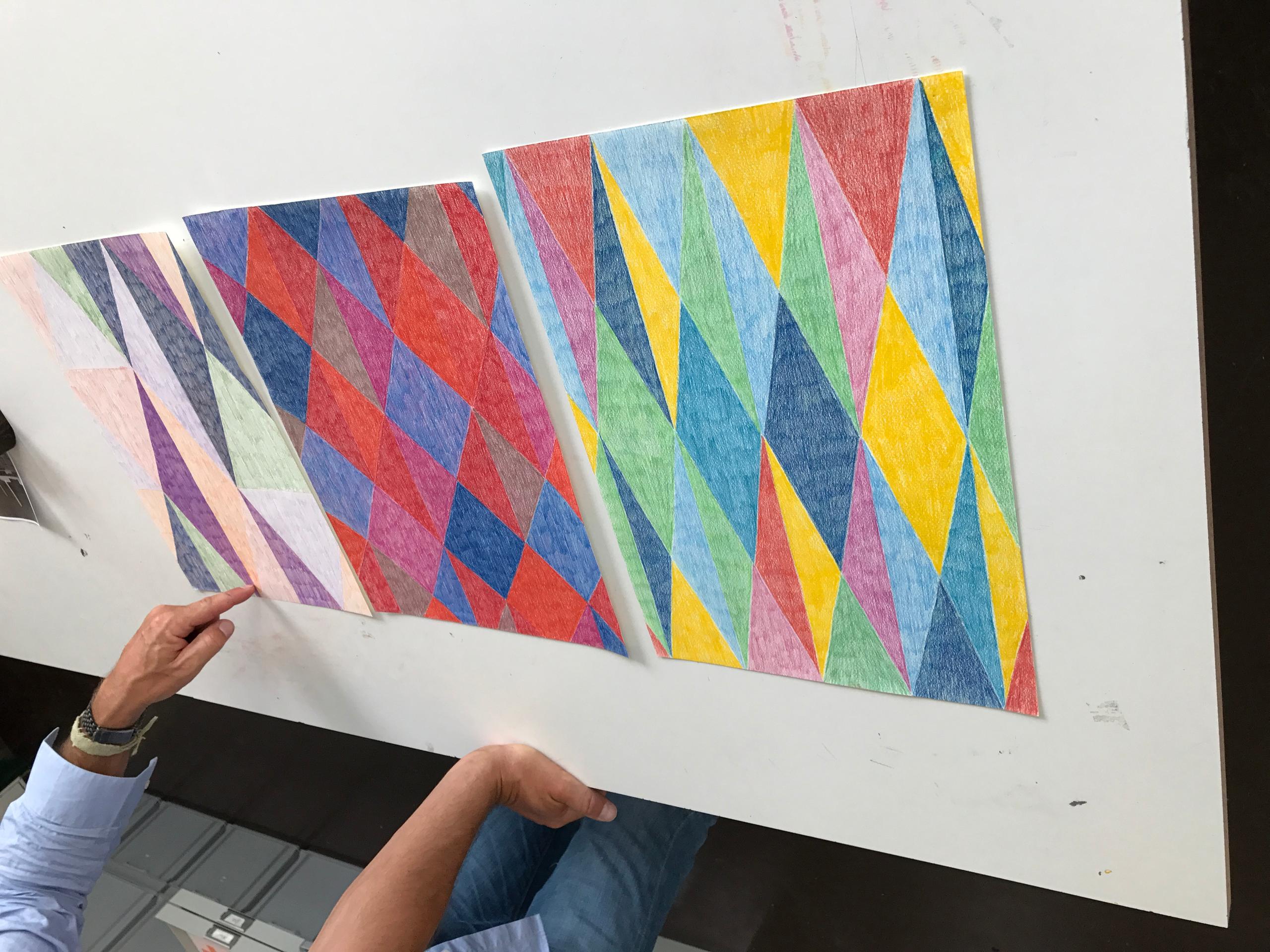 Noureldin creates abstract work on wax paper using colour pencils.