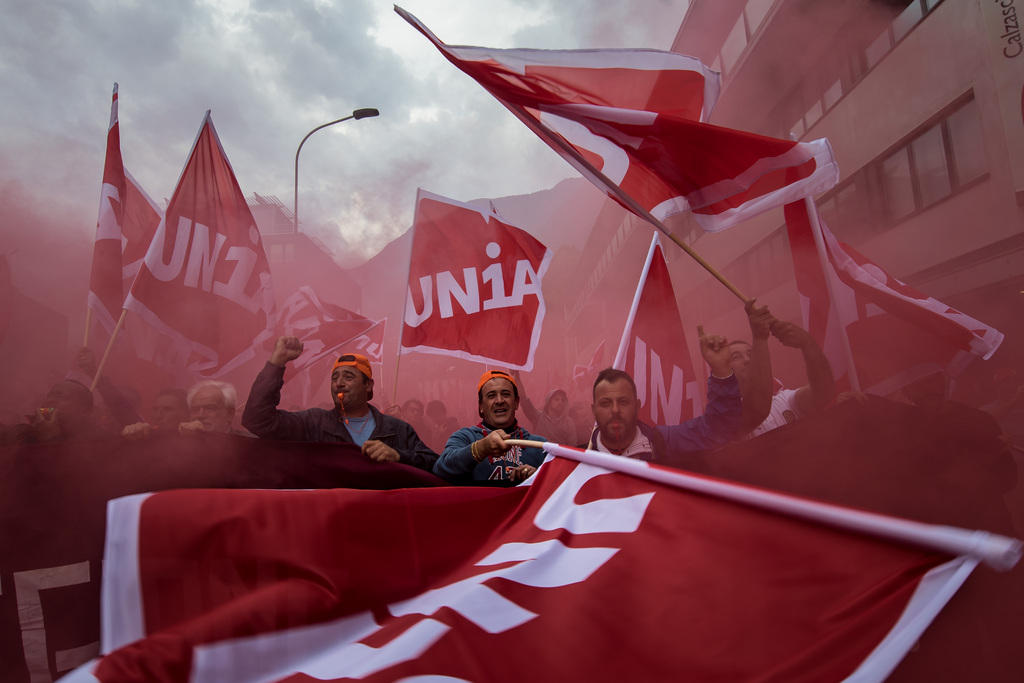 Striking workers with red banners