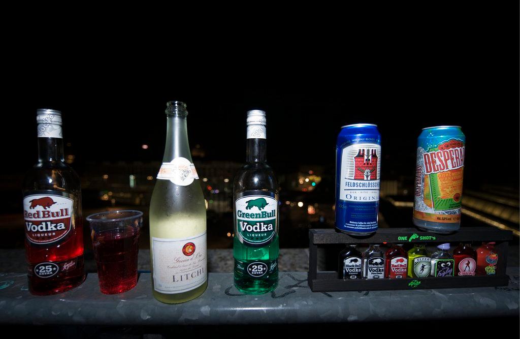 Empty bottles of alcohol sit on a wall