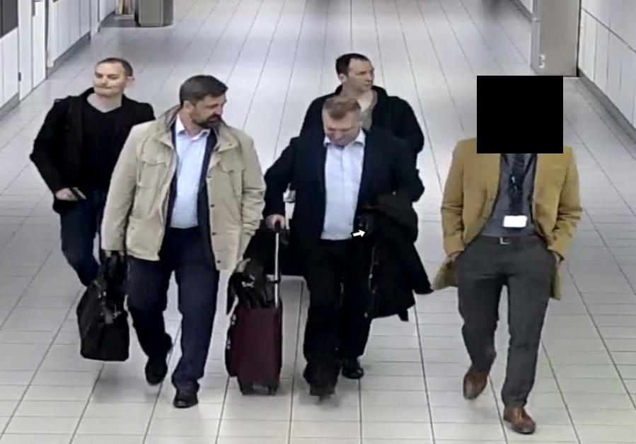 Four Russian GRU officers are escorted to their flight in the Netherlands after being expelled from the country