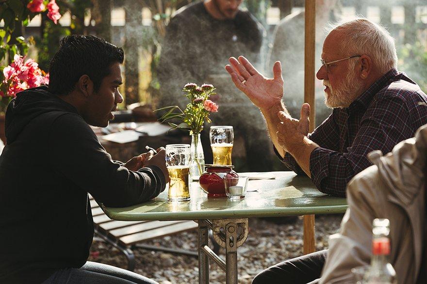 Two men discussing at a café