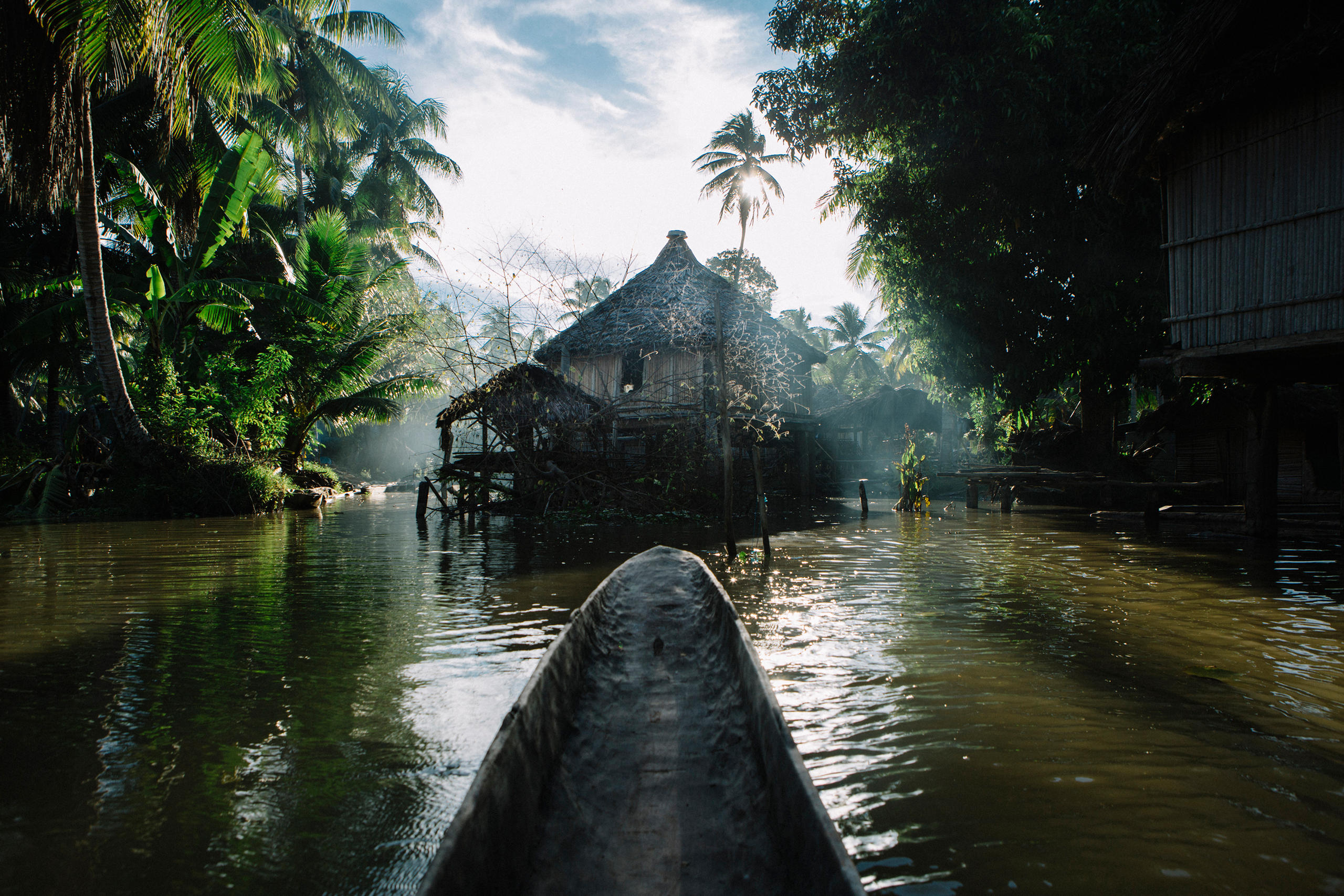 A canoe and a house on poles in Papua New Guinea