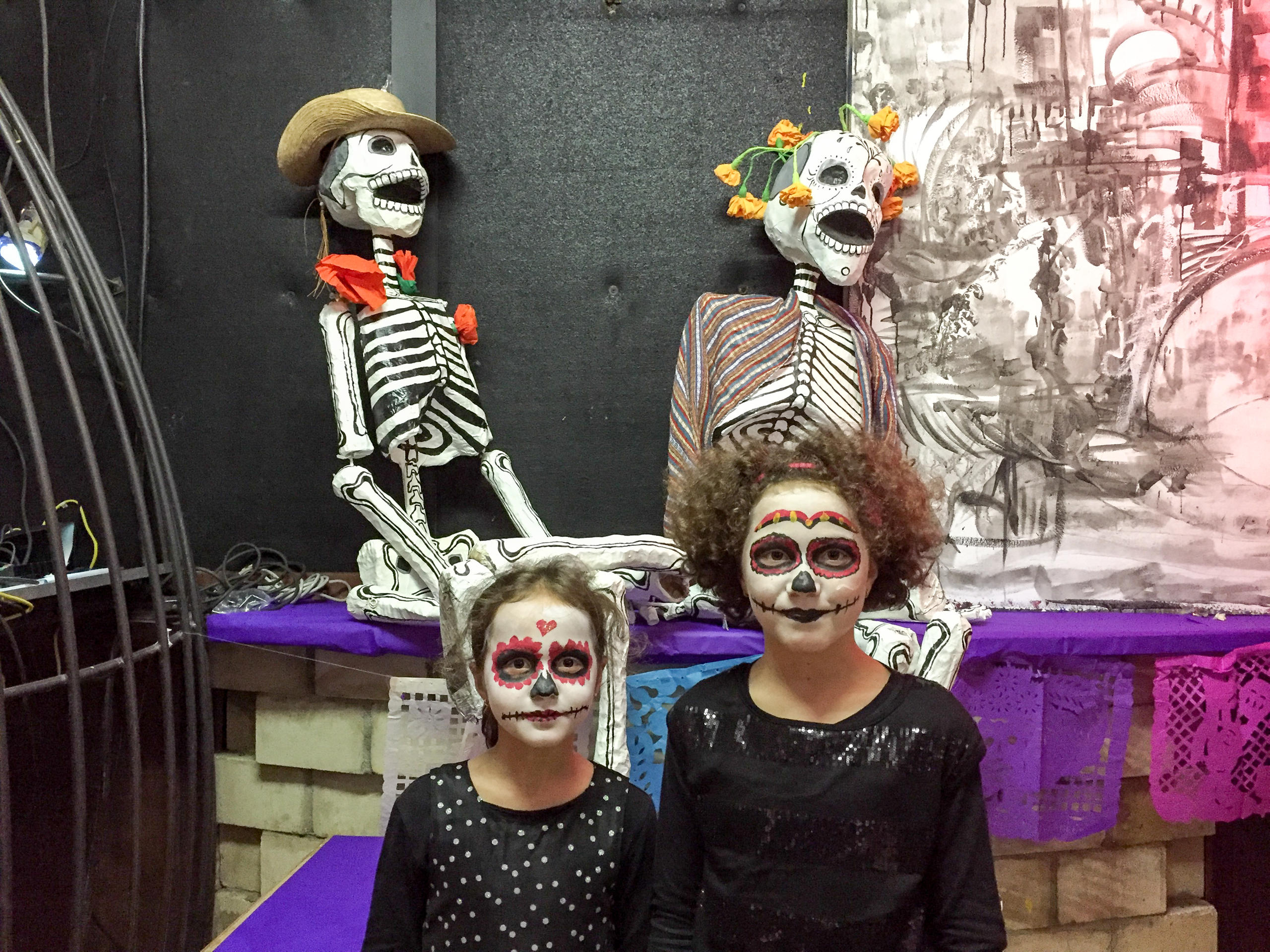 Two girls wearing skull makeup