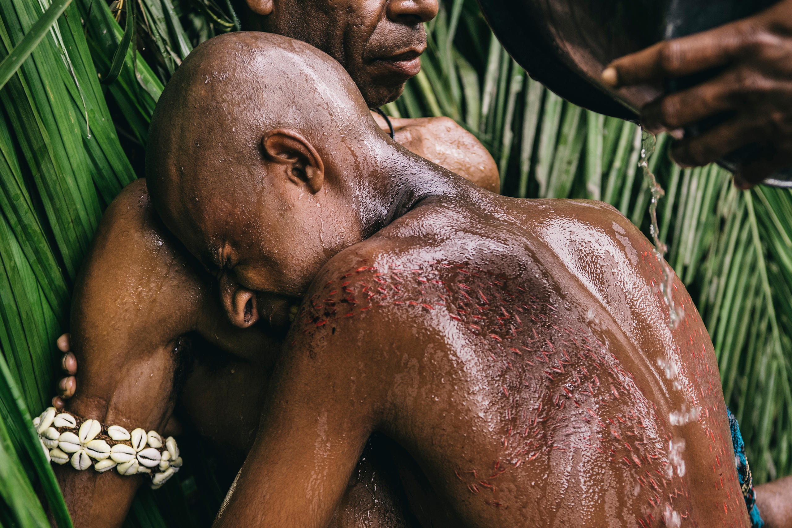 A man is being washed during a crocodile ritual in Papua New Guinea