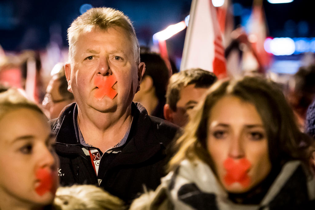 Manifestantes con cinta adhesiva sobre la boca