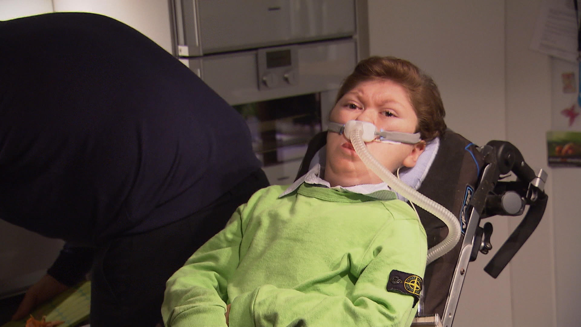 Child on breathing machine in chair