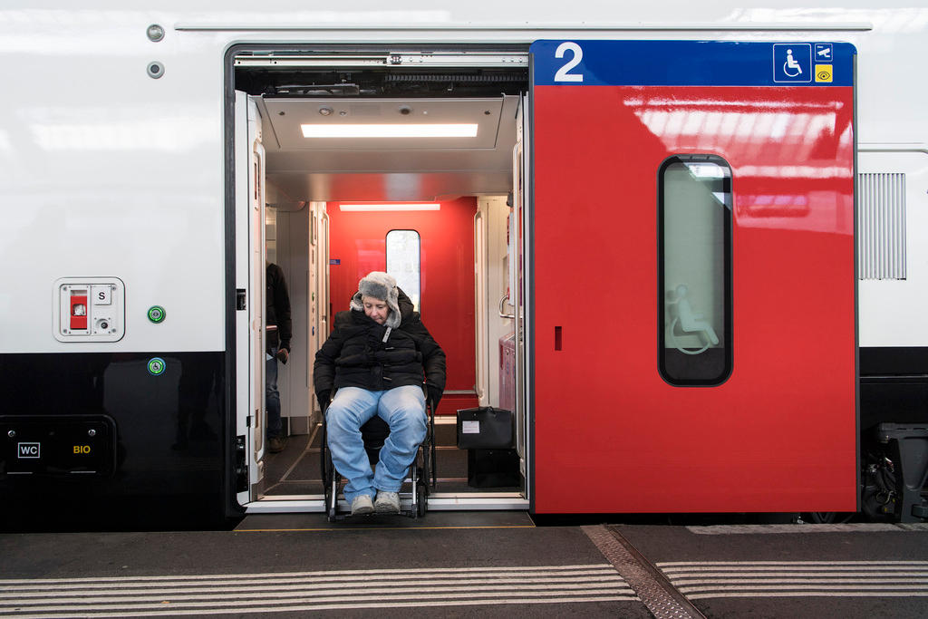Man in wheelchair exiting train door