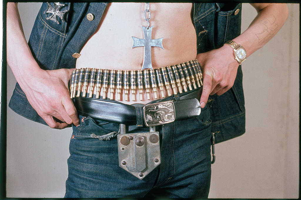 A mans midriff: Bullet belt, belt and padlock