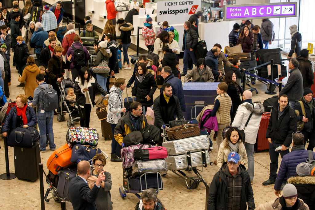 Passengers crowd Geneva airport