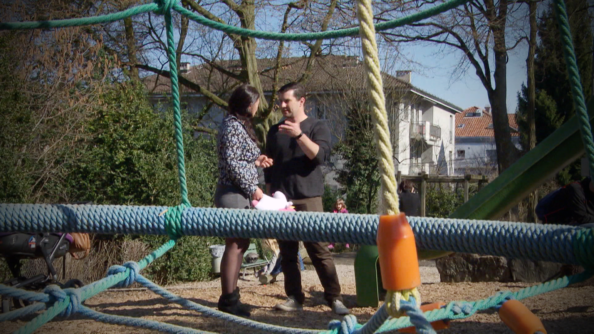 Woman and man talking in a playground