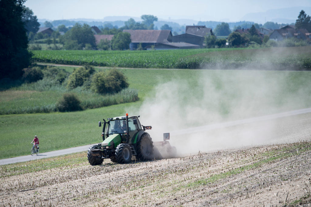 A farmer drives a tractor in canton Aargau