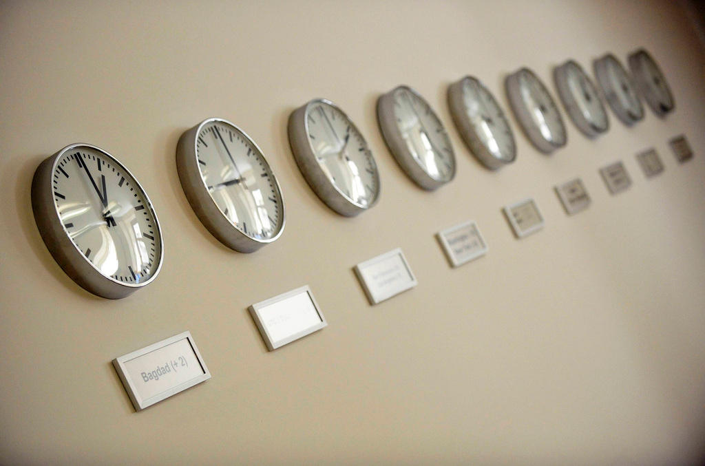 Clocks on a wall displaying different time zones