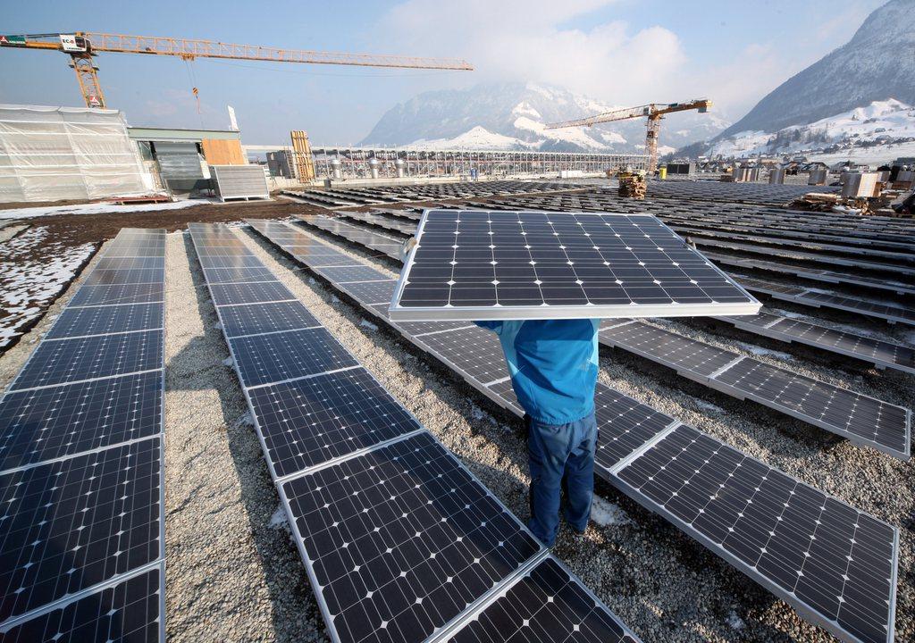 man carrying a solar panel