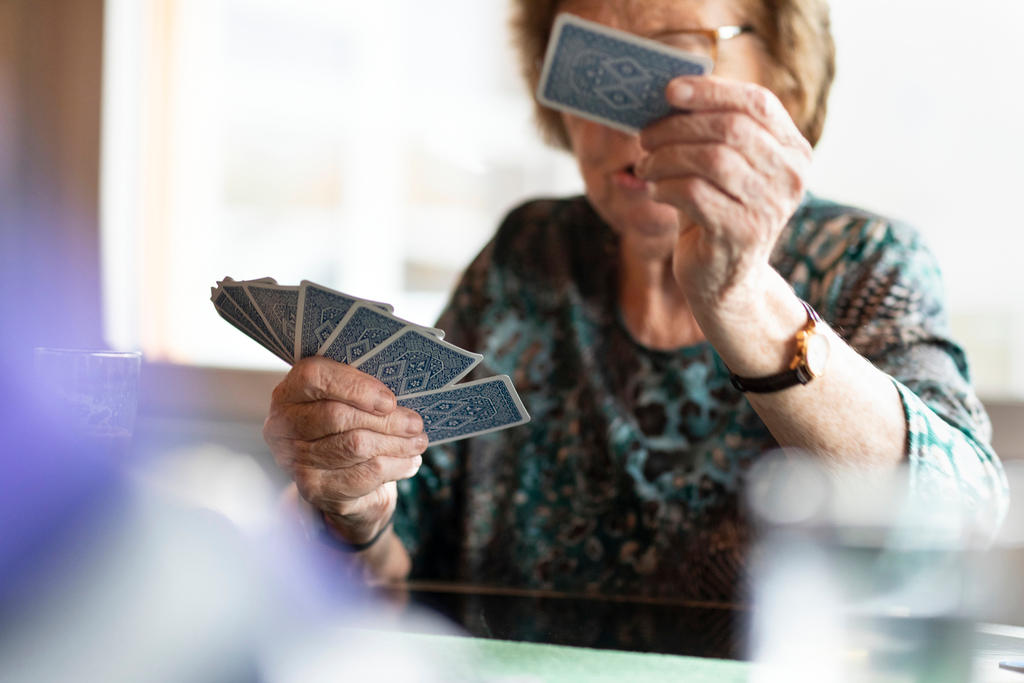 Old woman playing cards