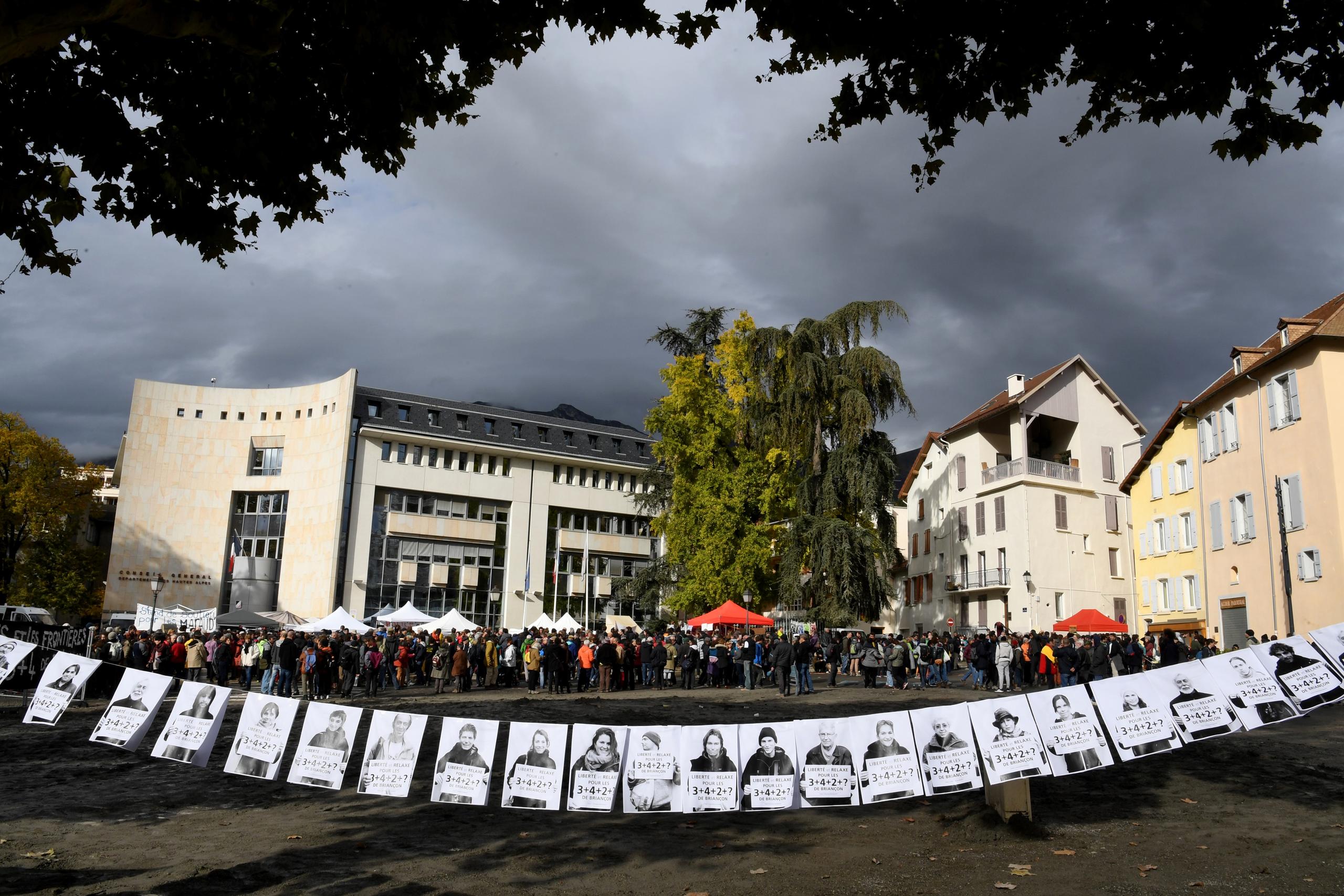 People wait outside the courthouse in Gap, France, on November 8
