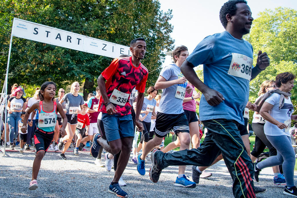 Men and children run out of starting line