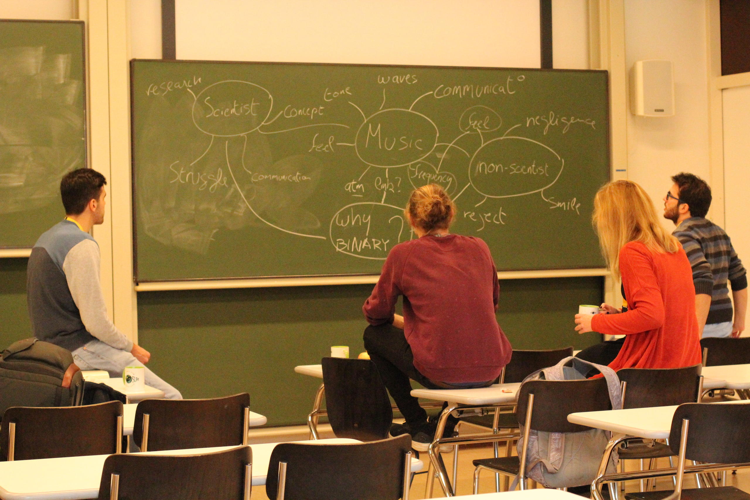 Hackathoners develop their ideas on a blackboard on Day 1