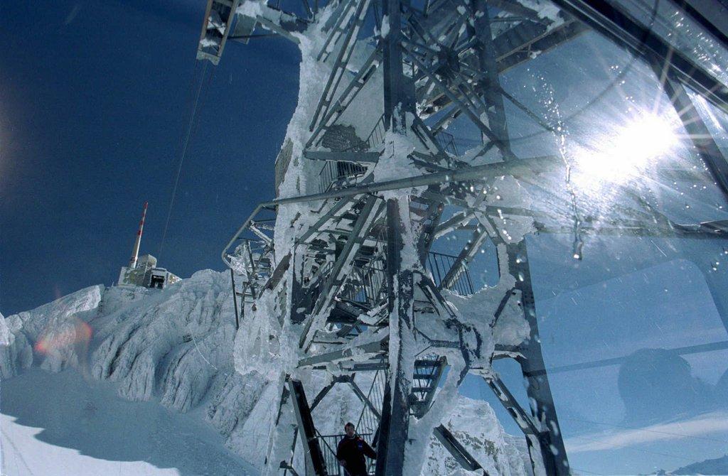 Support pillar of cable car covered in snow and ice