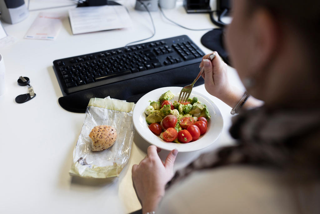 woman eating at desk