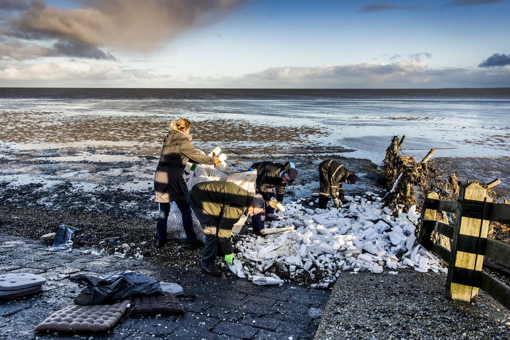 Volunteers clean up washed up content from container vessel in Netherlands