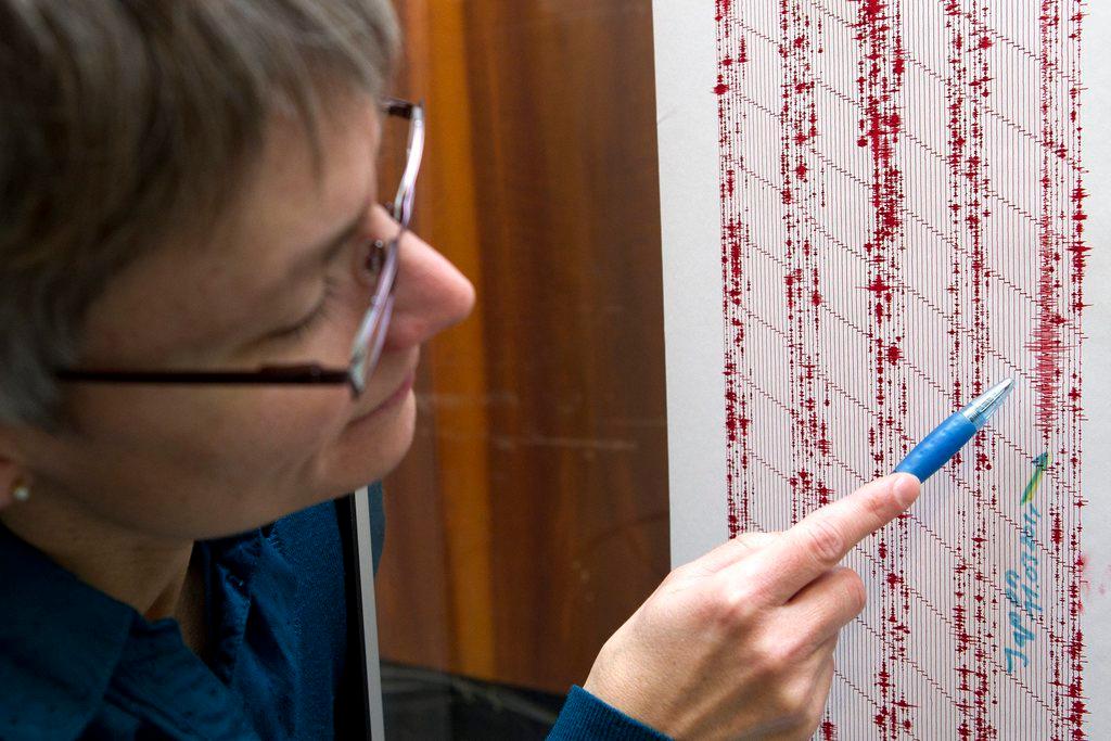 Geologist Corine Frischknecht points at seismograph lines