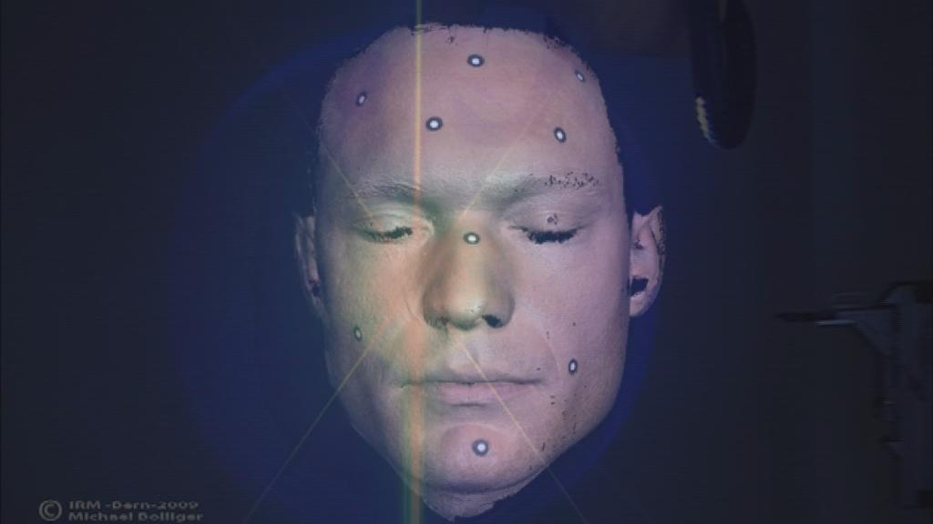 The face of a man covered with electrode pads for the virtual autopsy