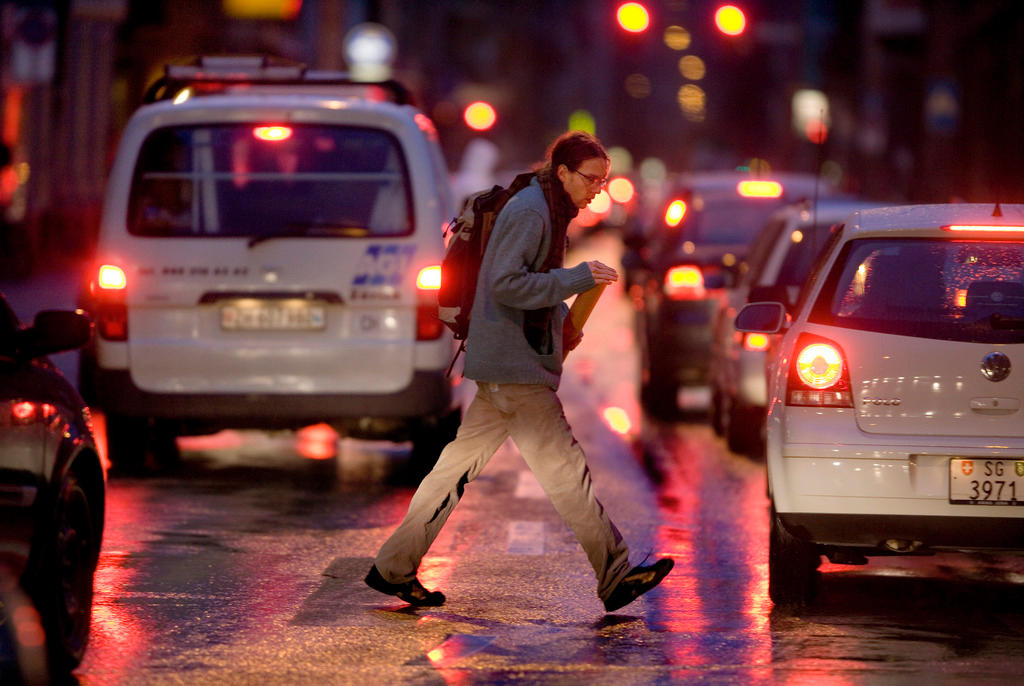 man crossing busy street