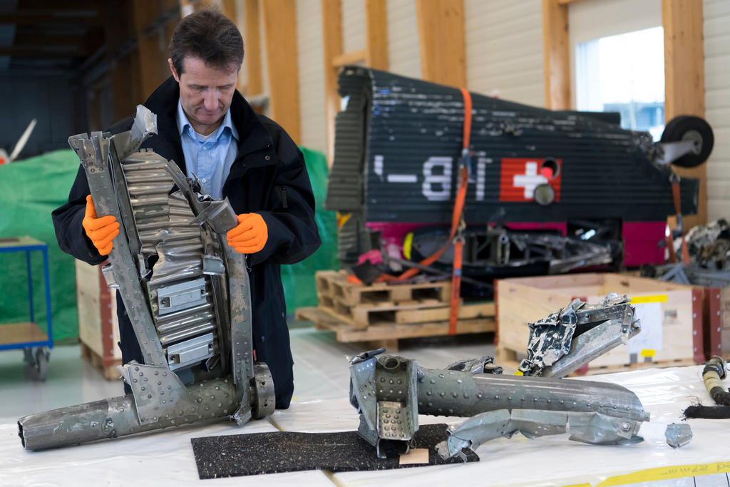 A man inspects the wreckage of an aircraft