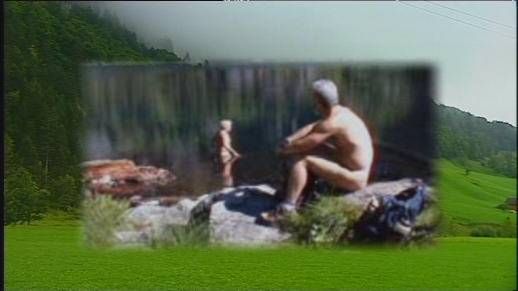 Two naked men take a break while hiking