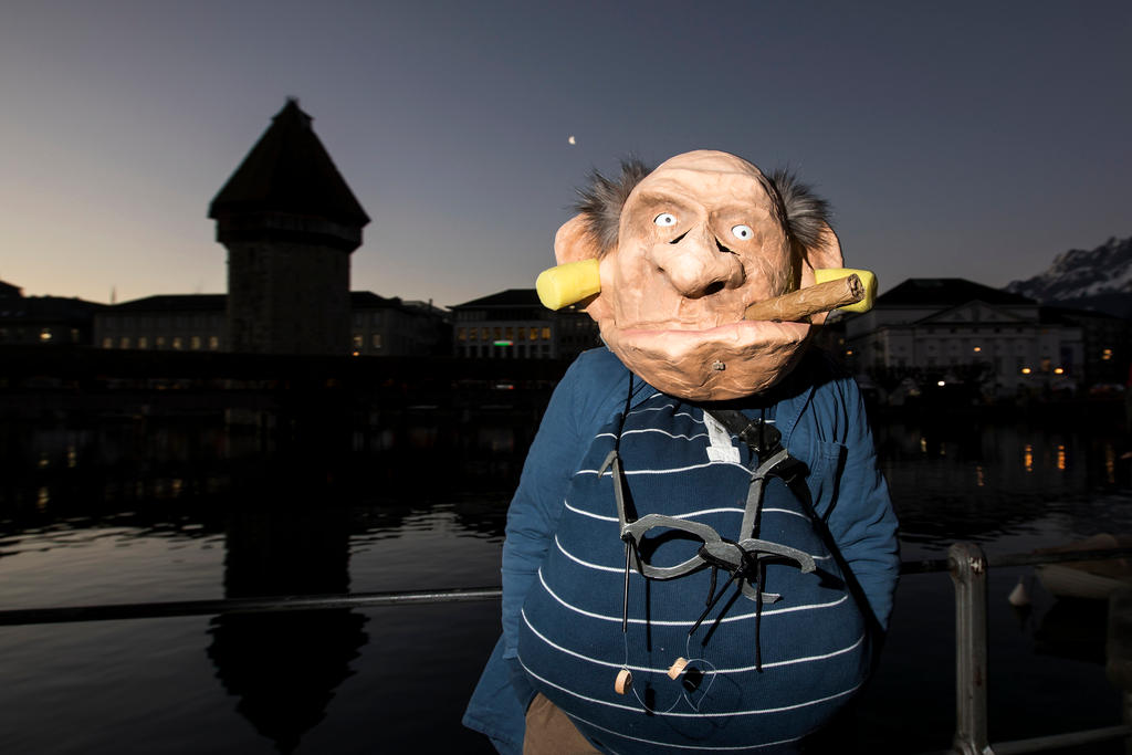 Carnival participant in front of Lucerne s bridge