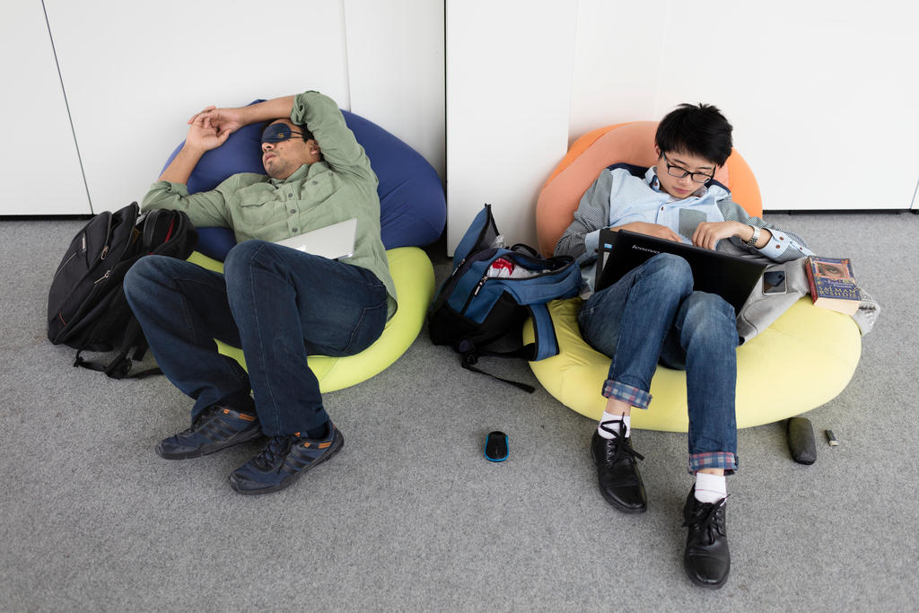 man asleep near laptop